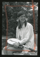 Sally Ride '72 wearing pigtails and holding a tennis racquet